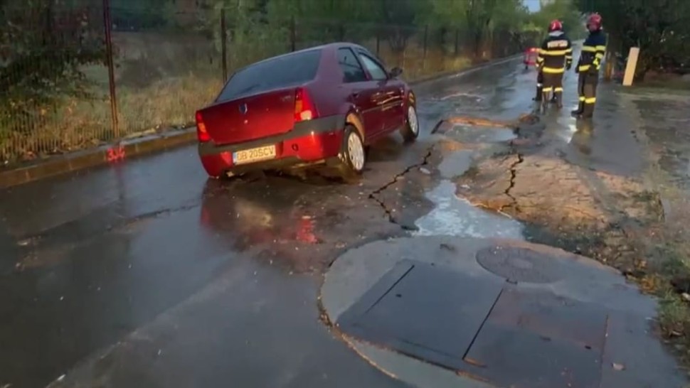 O șosea s-a surpat cu un autoturism deasupra. Bilanțul ploilor de duminică din București și Ilfov FOTO
